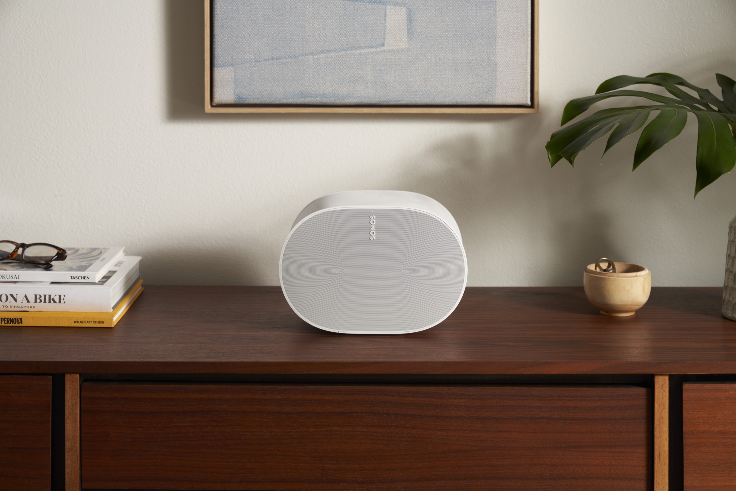 Sonos Era speaker placed on a credenza in a living room