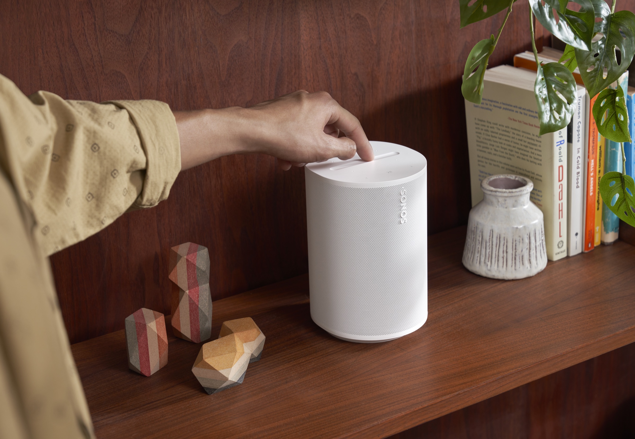 Sonos Era 100 placed on a bookshelf for balanced sound